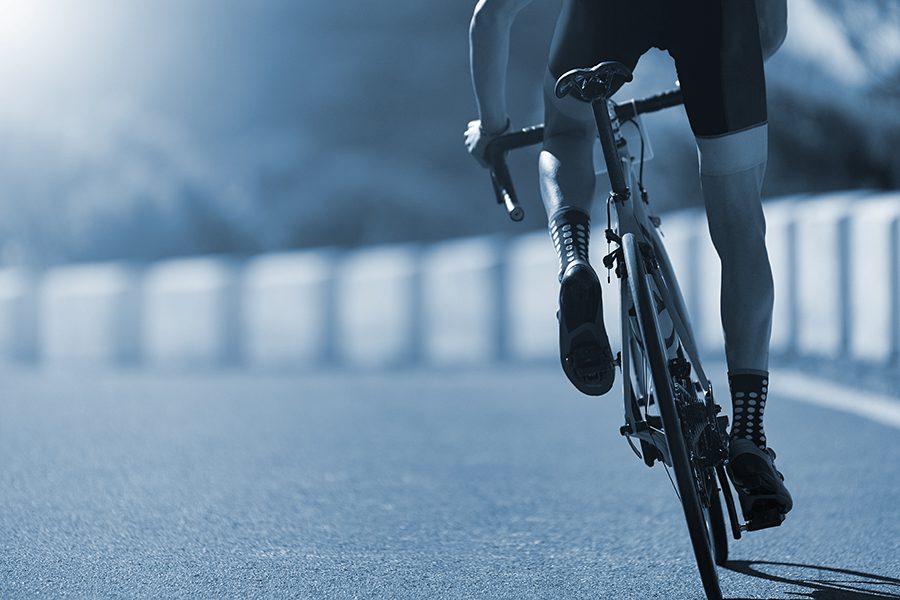 Bicyclist rides on the road near the shoulder