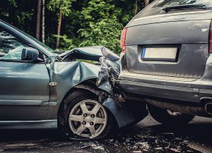 Light blue sedan rear-ends a grey SUV