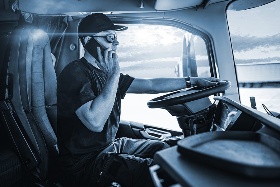 Truck driver talking on his cell phone