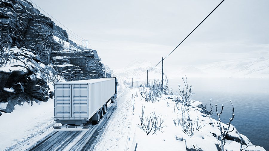 Red truck transport with container on winter road