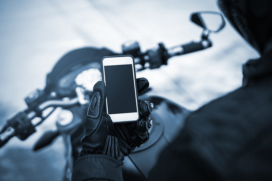 Motorcycle rider holding a smart phone