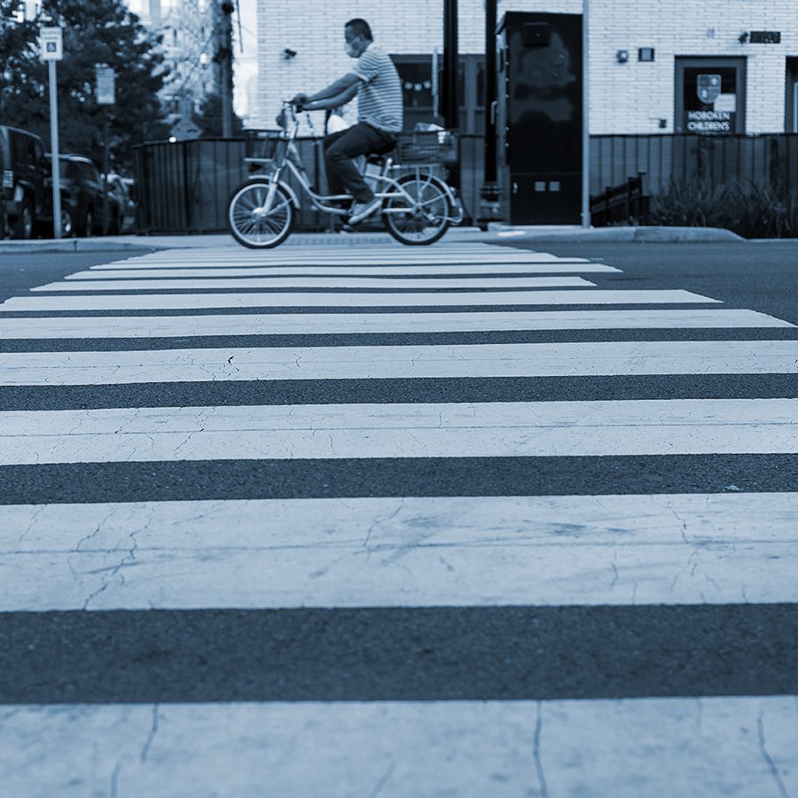 Bicyclist rides through a crosswalk