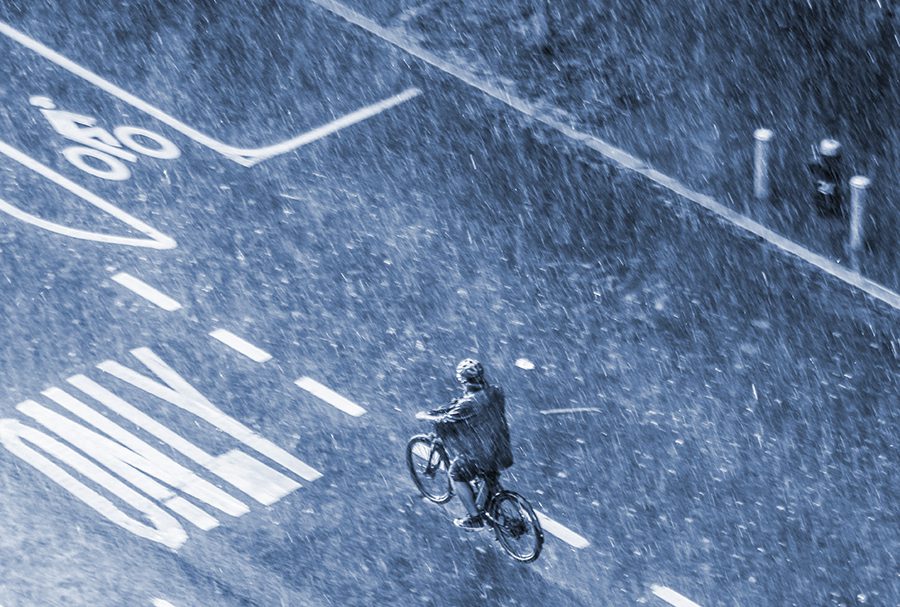 bicyclist riding through a heavy rainstorm