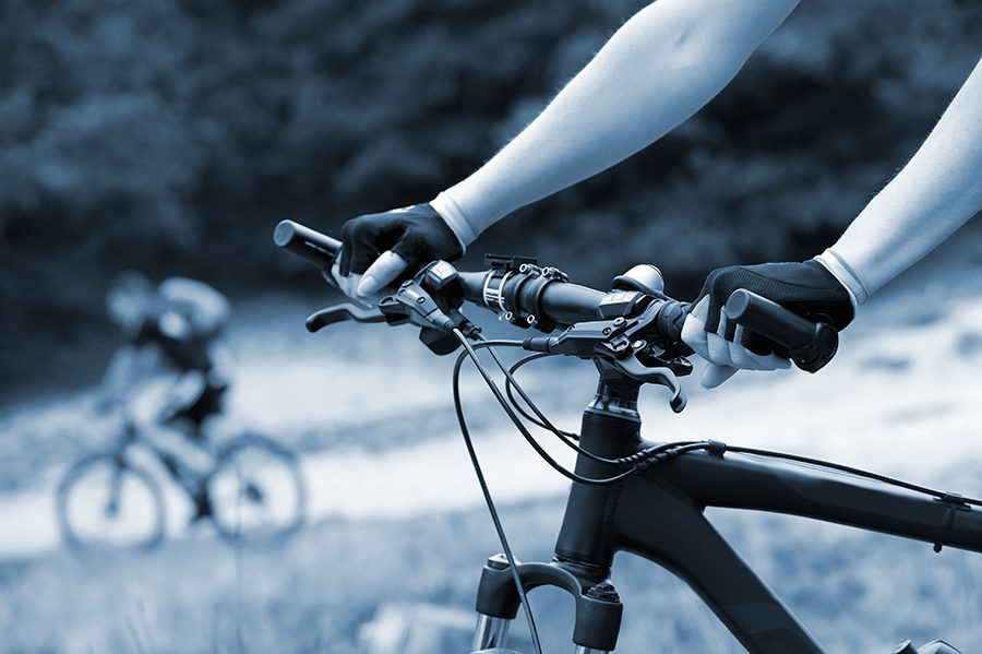 close up on hands on a handle bar