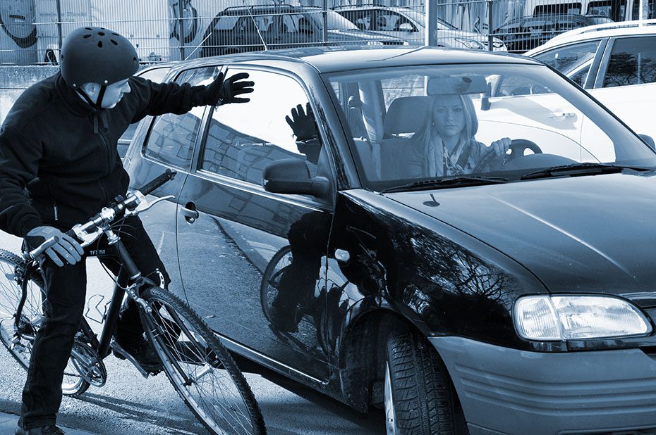 Car gets too close to a bicyclist and hits them on the side.