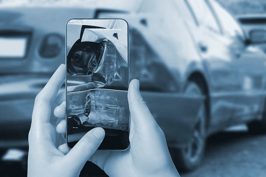 Person takes photo of car damage after an accident