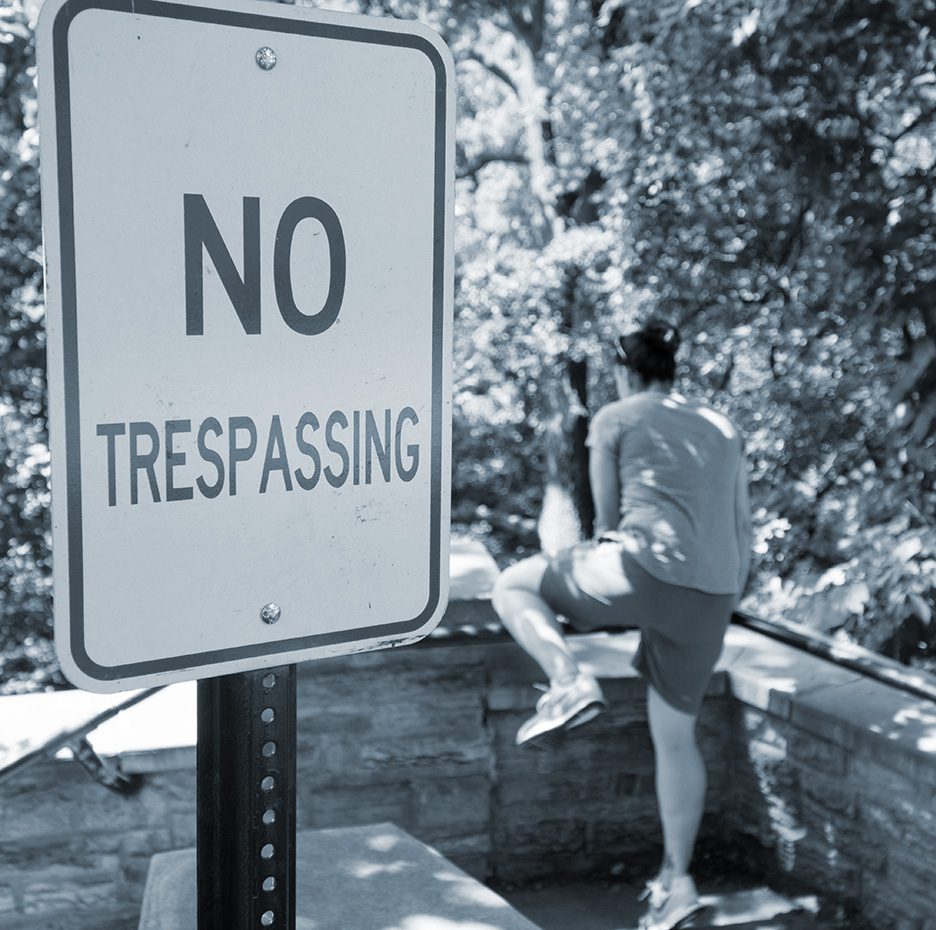 Man trespasses onto private property. No trespassing sign