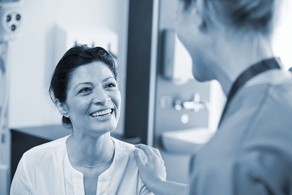 Patient is comforted by her doctor. 