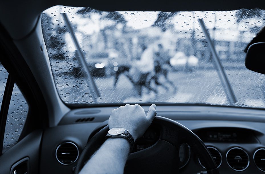 Pedestrians on a crosswalk from the windshield of a car