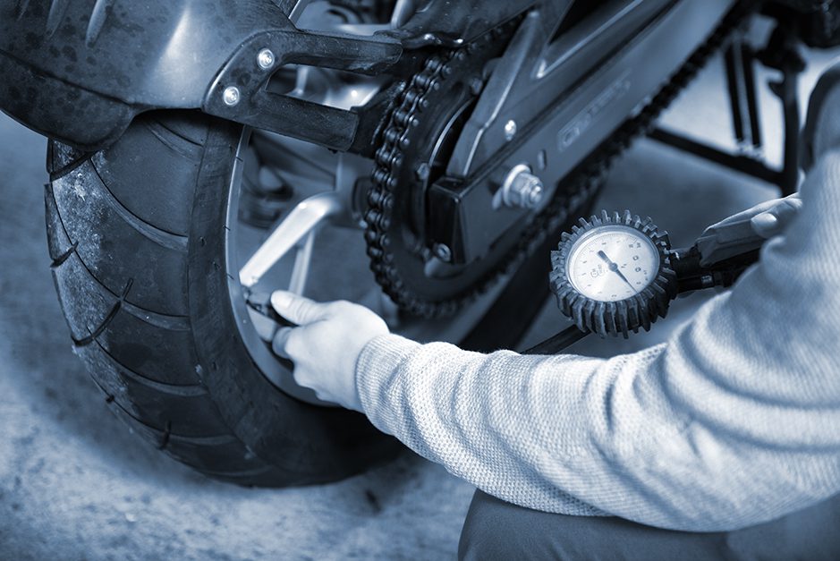 Person inflates tires to the proper pressure before he rides.