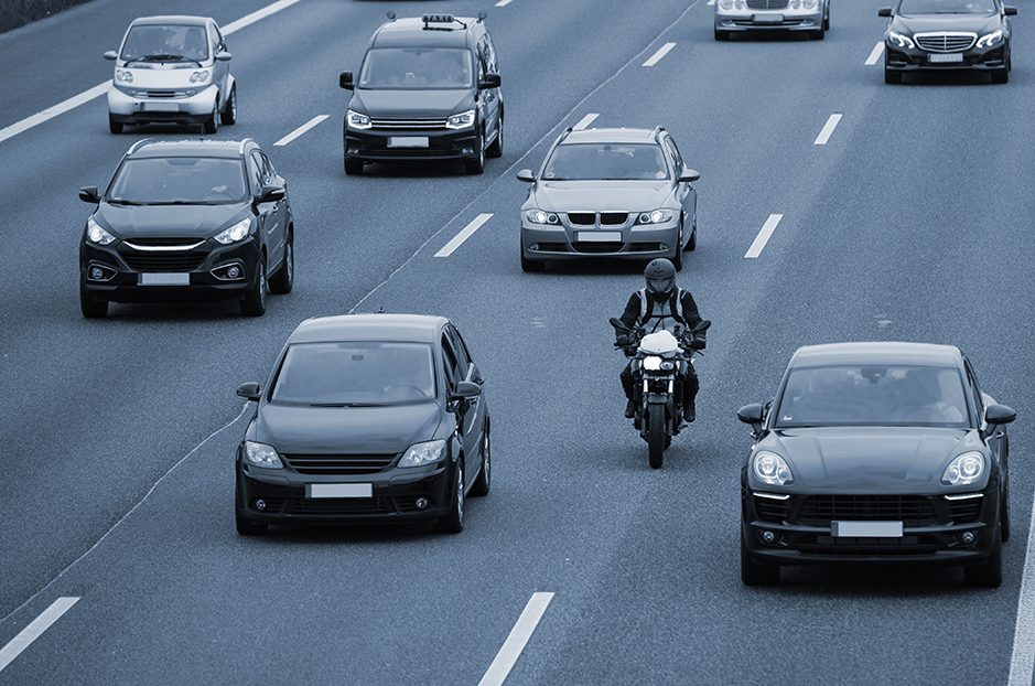 Motorcyclist lane splits down the freeway.