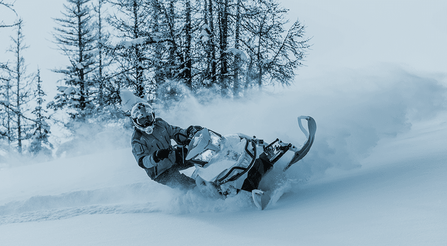 Snowmobile rides in deep snow