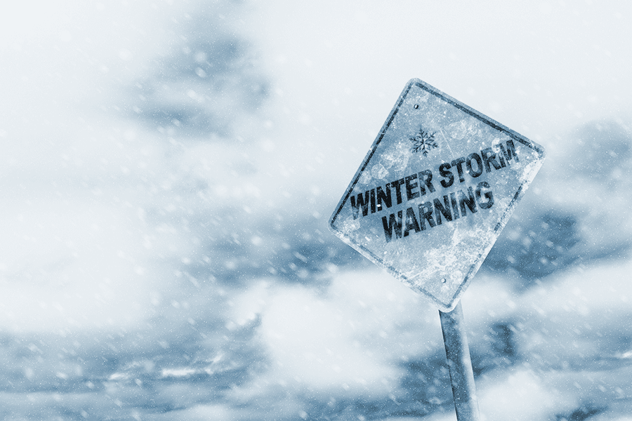 Winter Storm warning sign in snow storm