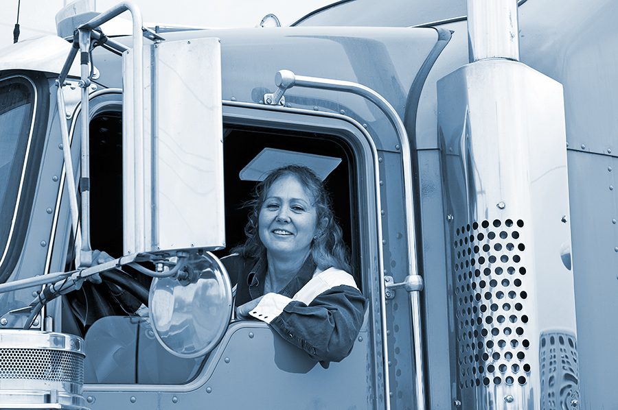 female truck leans arm outside of the truck's window