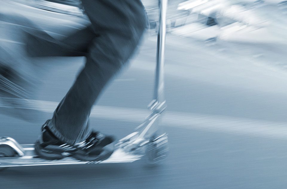 Motion blur of child riding a scooter