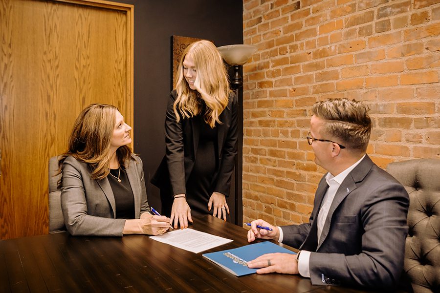 Three lawyers have discussion in meeting room