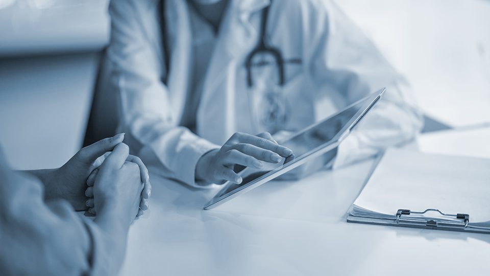 Shot of a doctor showing a patient some information on a digital tablet