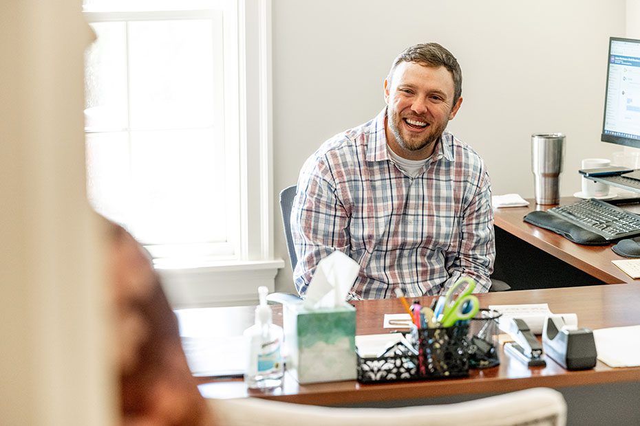 Attorney welcomes client into his office 