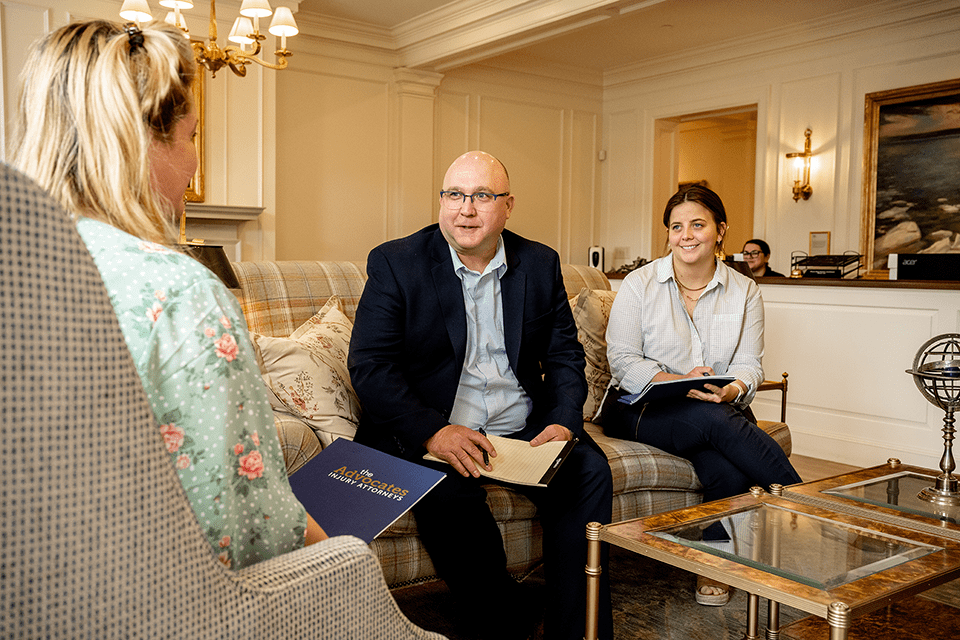 Attorneys meet with client in a reception area