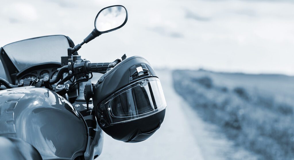 Helmet hanging of the handlebars of a motorcycle