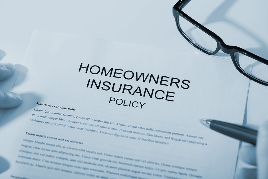 homeowners insurance policy with glasses and pen. 