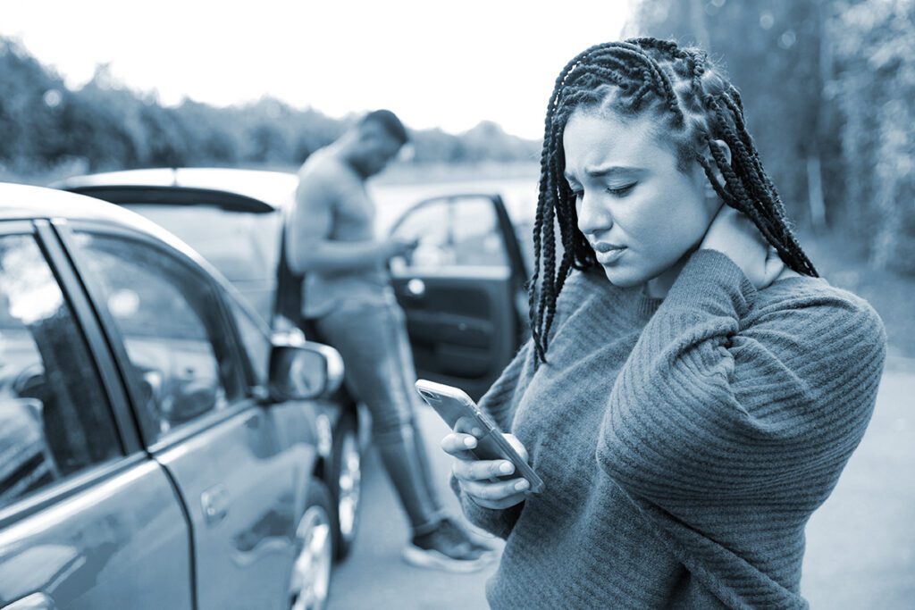 Woman check phone after a car accident