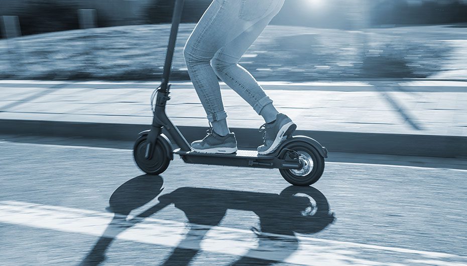 action shot of electric scooter riding in the bike lane