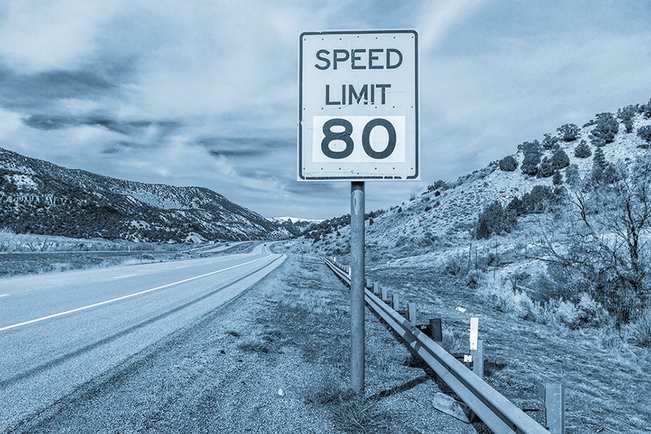80 mile per hour highway sign on a desert highway