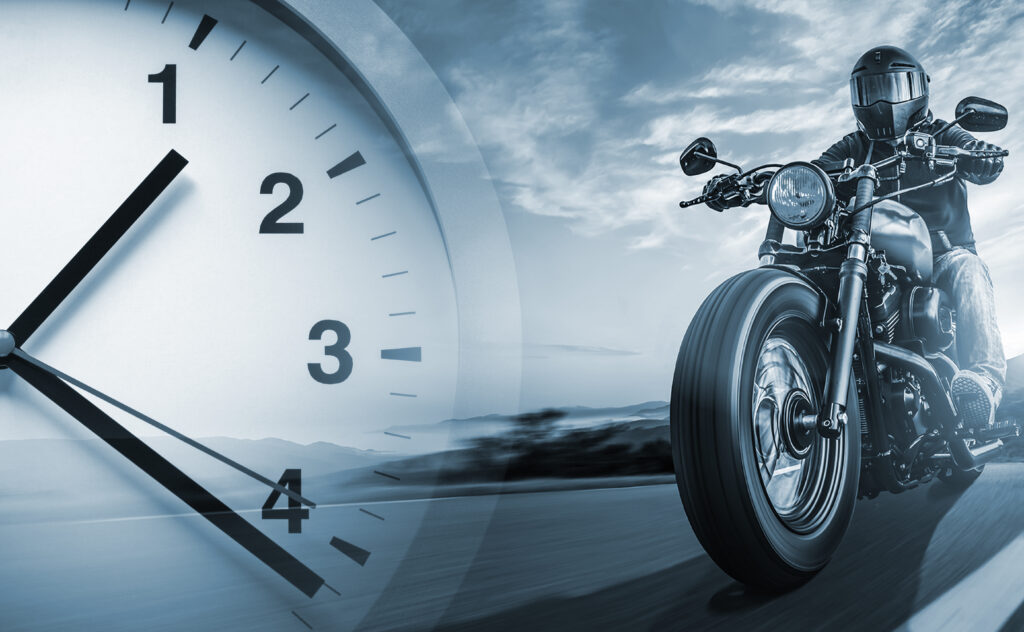 Graphic with clock and motorcycle rider going down a highway