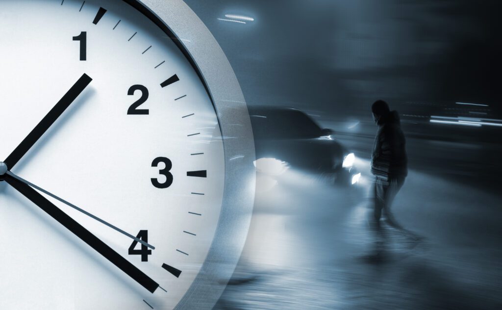 half clock with background of a man about to be hit by a car