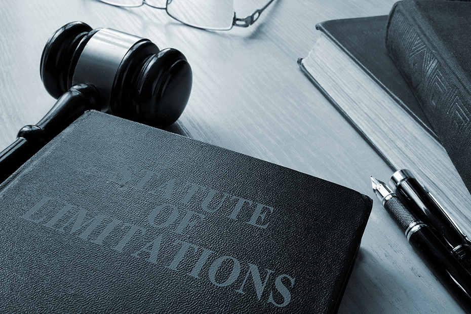 Gavel and legal book of statute of limitation on a wood desk