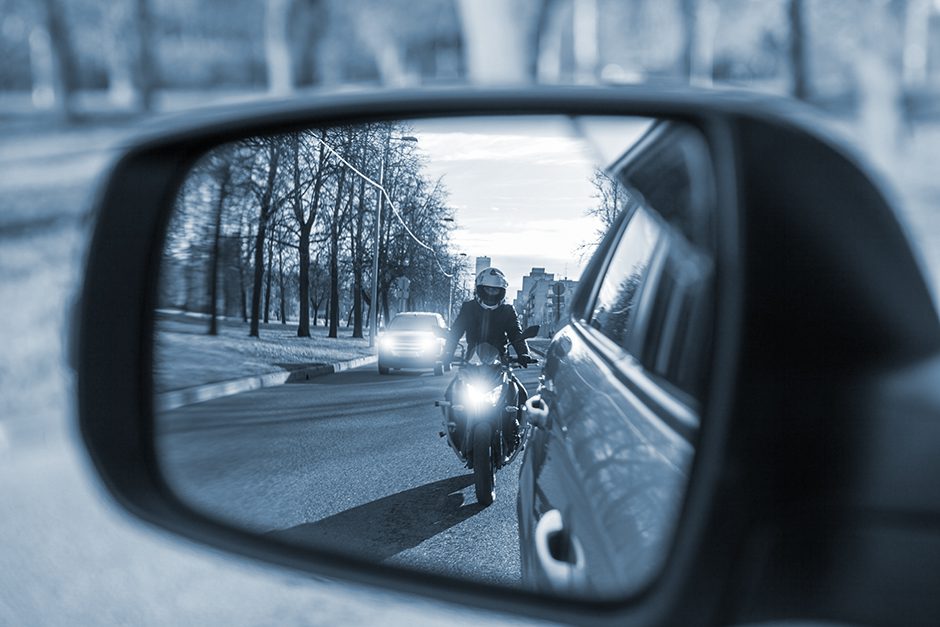 Visual of Motorcyclist in in the side mirror of a car