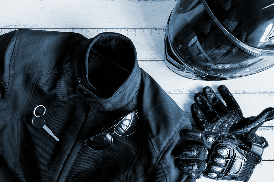 Motorcycle saftey: Helmet, gloves, and jacket on a table
