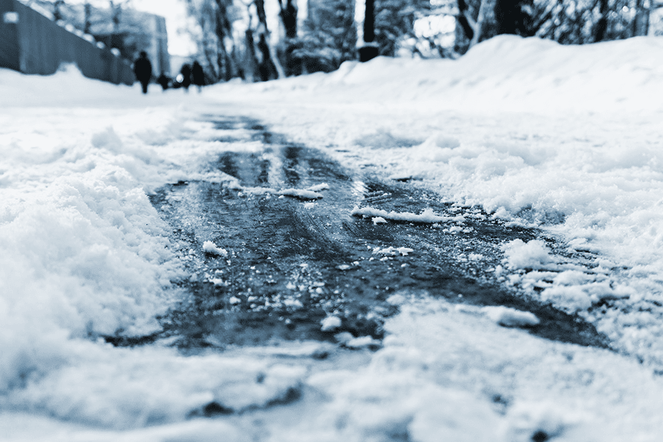 Icy Sidewalk underneath cleared snow.