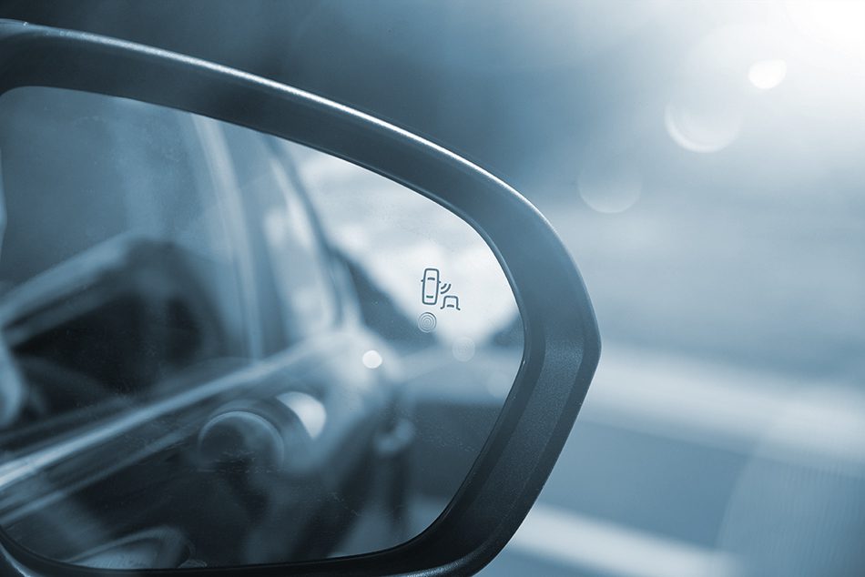 Rear view mirror on the passenger side of the car. 