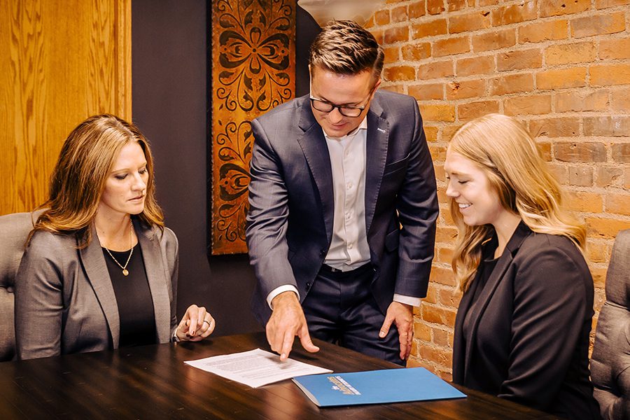 Three attorneys in a meeting room.