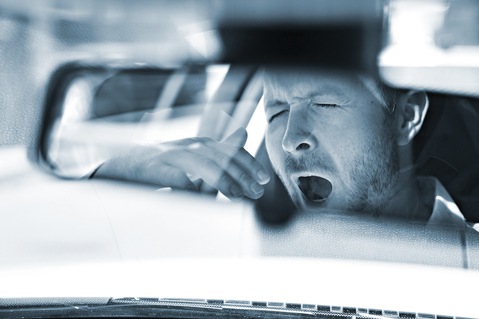 Tired Man Yawns while Driving.