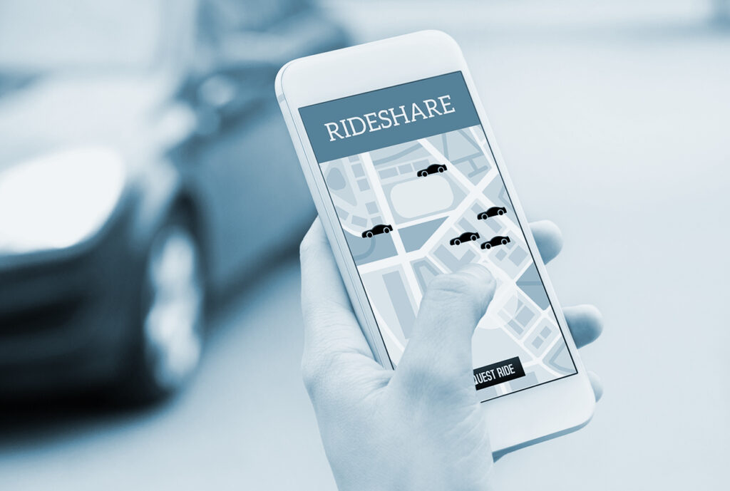 Ride share taxi service on smartphone screen. Online rideshare app and carpool mobile application. Woman holding phone with a car in the background.