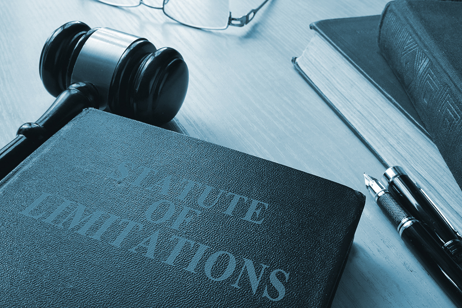 Law book of statute of limitation with a gavel on a desk