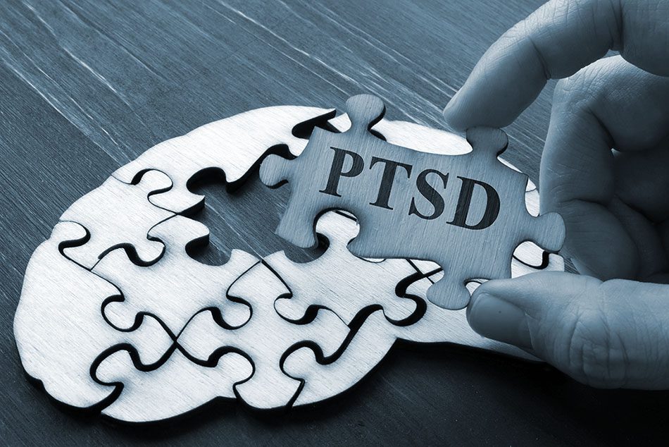 Puzzle pieces with one that say PTSD