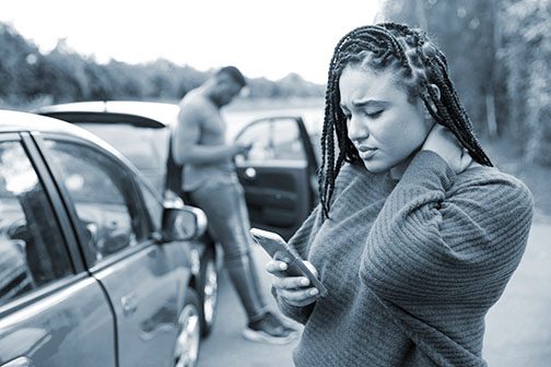 Women grabs her neck after a car accident
