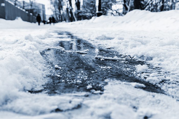 A snowy, slushy walkway presents a risk for slip and fall injuries