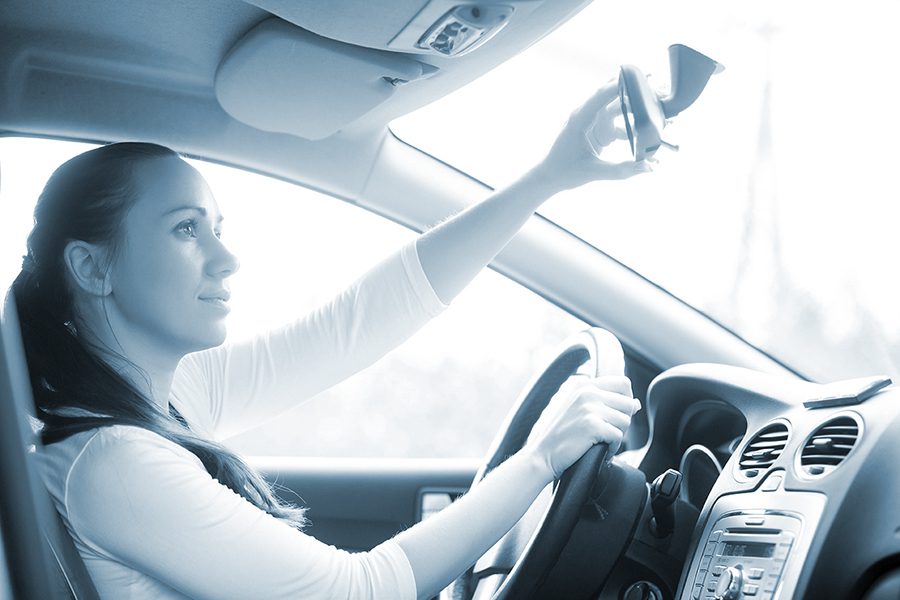 Young woman yawning in the car