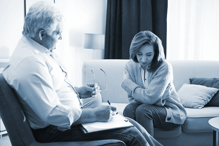 Grief counselor comforts a grieving widow