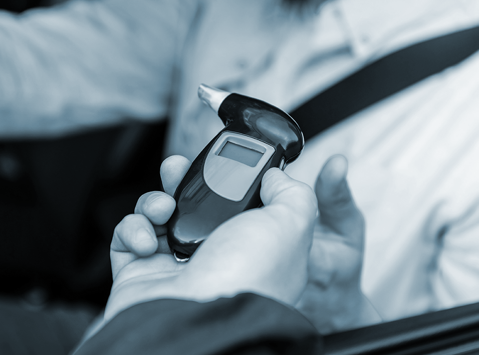 Breathalyzer being used on a potential drunk driver