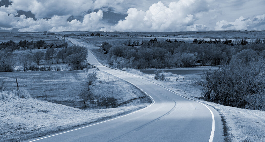 A highway traversing an agriculture area in the Oklahoma panhandle
