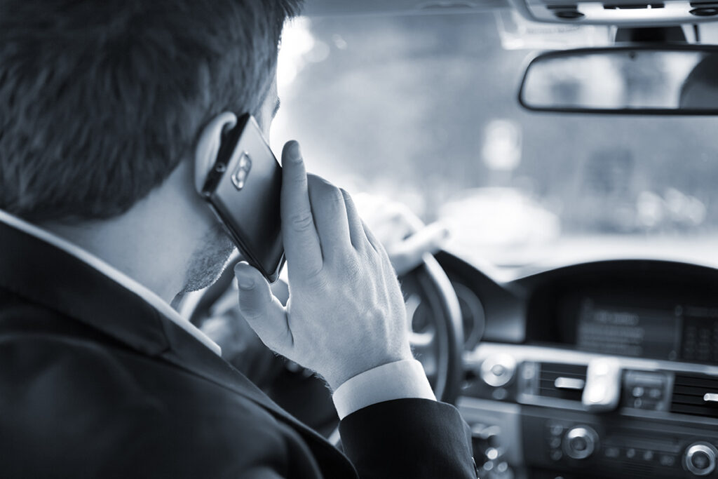 Man talking on the phone on his car
