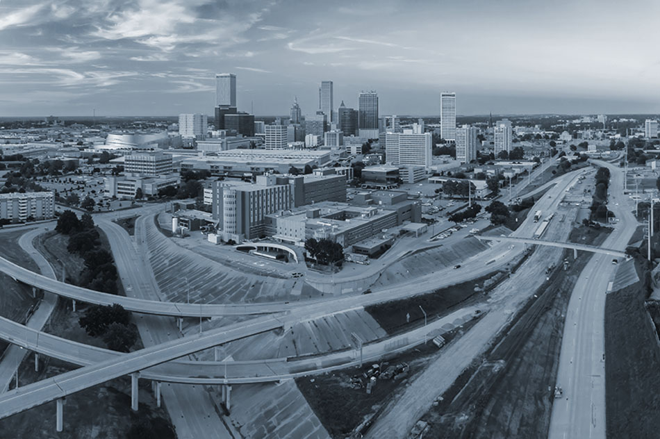 Freeway and downtown Tulsa city skyline at sunset