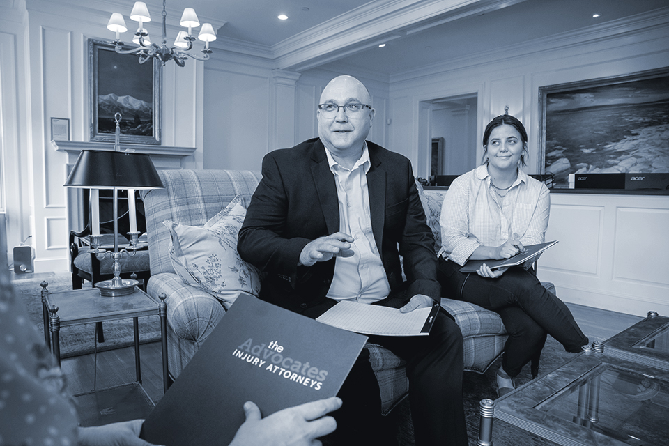 Attorney speaks to client in an office lobby